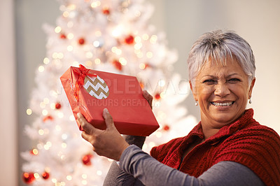 Buy stock photo Senior woman, portrait and gift for Christmas, happiness with box and celebrate holiday at home. Festive season, decoration and present with smile on face, package or parcel with xmas surprise