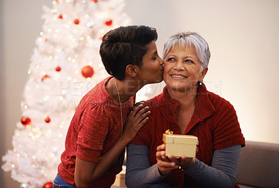 Buy stock photo A mother and daughter exchanging gifts on Christmas