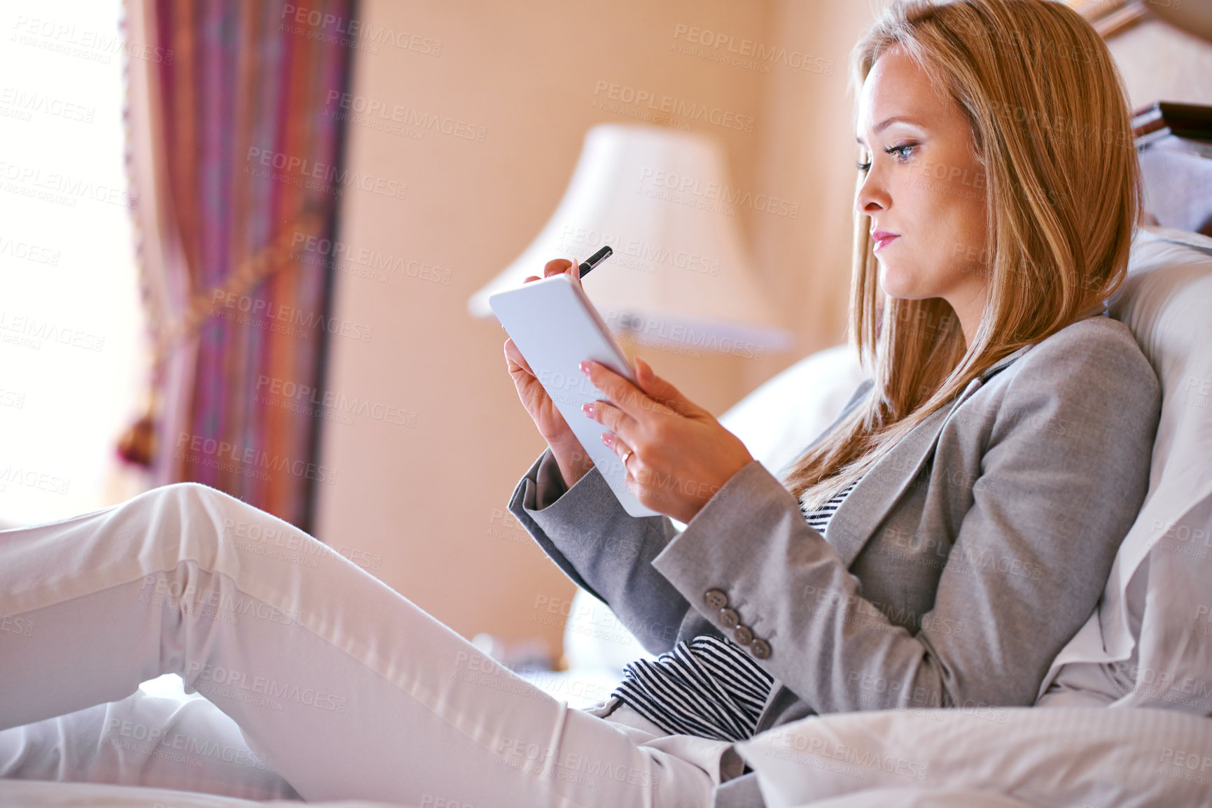 Buy stock photo Business woman, tablet and portrait in hotel room with planning and working for case with travel. Technology, bed and employee with reading, attorney brief and online email of a law professional