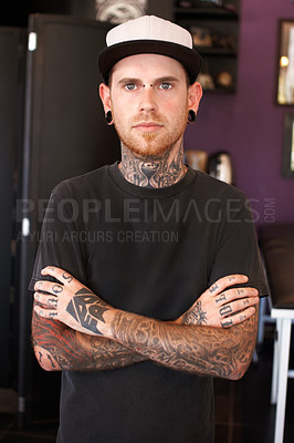 Buy stock photo Punk, tattoos and portrait of a male artist standing with crossed arms for confidence in his studio. Serious, cool and face of grunge man with edgy, funky and body art or ink creative business store.