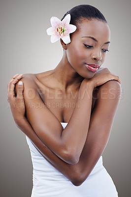 Buy stock photo Beauty, flower and black woman with skincare, shine and dermatology on a grey studio background. African person, girl and model with organic cosmetics and natural treatment for glow, orchid or clean