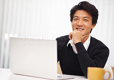 Buy stock photo Portrait of a handsome asian businessman working at his desk