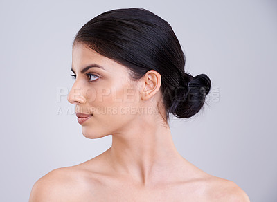 Buy stock photo Calm woman, face and profile with skincare, cosmetics or facial treatment on a gray studio background. Young female person, brunette or model with smile in satisfaction for beauty, makeup or spa