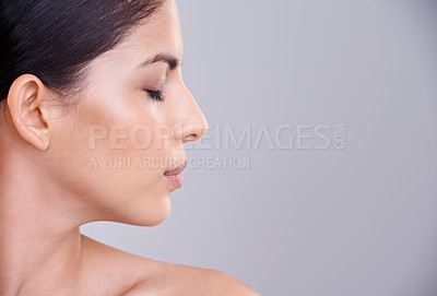 Buy stock photo Woman, relax and profile with face in cosmetics, facial treatment or skincare on a gray studio background. Young female person, brunette or calm model in satisfaction for beauty or makeup on mockup