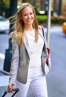 Buy stock photo Business woman, baggage and portrait on walk in city with smile for journey with pride, suit and outdoor. Person, happy and luggage for travel on metro sidewalk by skyscraper buildings in New York
