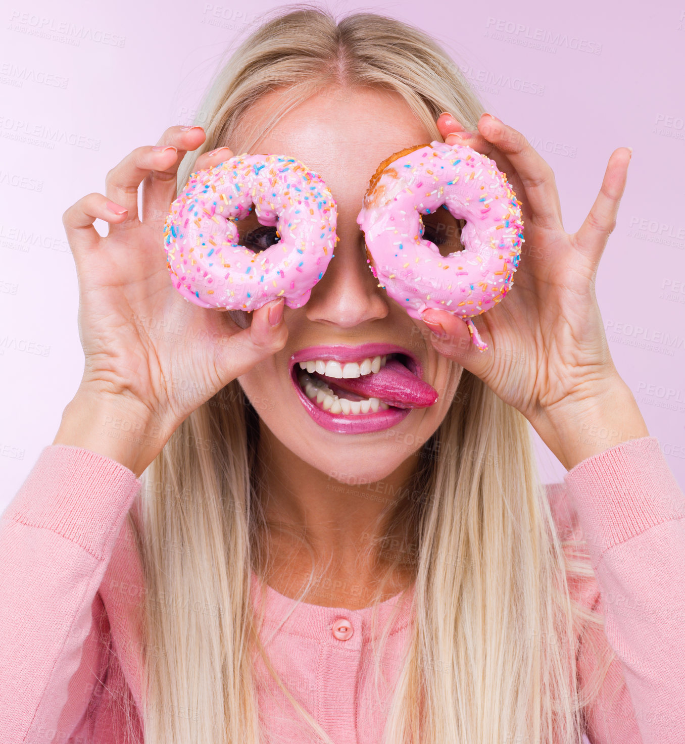 Buy stock photo Donut, silly and portrait in studio for dessert, frosting and pink for sprinkles and sweet for sugar and crazy. Young person with tongue out for funny, comic and pastry for cake and icing for color 