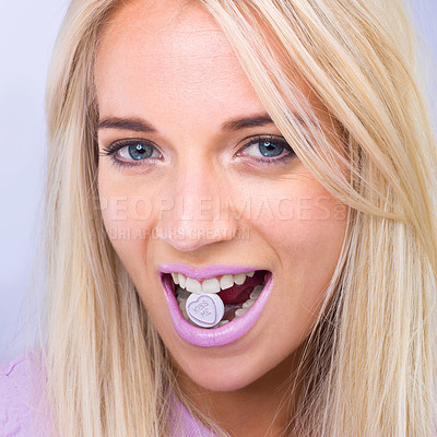 Buy stock photo Woman, beauty and studio portrait with candy in mouth with makeup, lipstick or heart sign by purple background. Girl, person and model in closeup with sweets, emoji or happy for eating with cosmetics