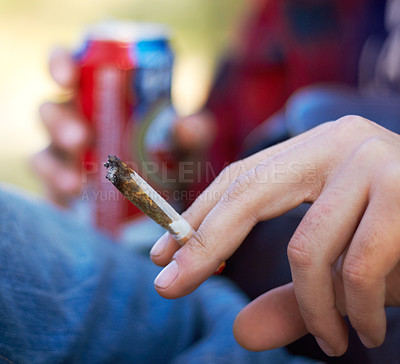 Buy stock photo Shot of a unrecognizable person smoking a large marijuana joint