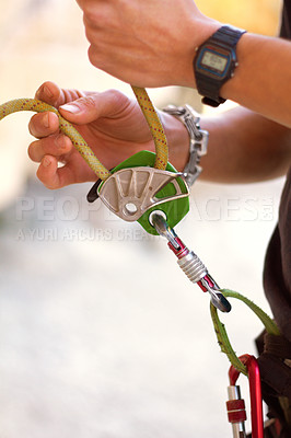 Buy stock photo Hand, closeup and rock climbing in safety harness for adventure, hiking or outdoor gear in summer. Hiker, rope knot or mountaineer in nature for exercise, training or fitness for freedom in sunshine