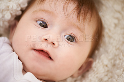 Buy stock photo Happy, cute and closeup of baby on blanket playing for child development and curious face. Smile, sweet and young girl kid, infant or newborn relaxing and laying on bed in nursery room at home.