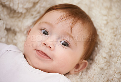 Buy stock photo Happy, cute and face of baby on blanket playing for child development and curious facial expression. Smile, sweet and girl kid, infant or newborn relaxing and laying on bed in nursery room at home.