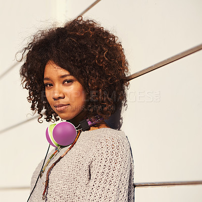 Buy stock photo A young woman with headphones around her neck