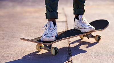 Buy stock photo A cropped shot of a woman standing on a skateboard