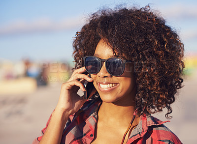Buy stock photo A trendy young african american woman smiling while using her mobile