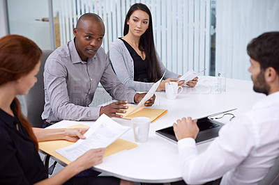 Buy stock photo Shot of colleagues sitting in a meeting