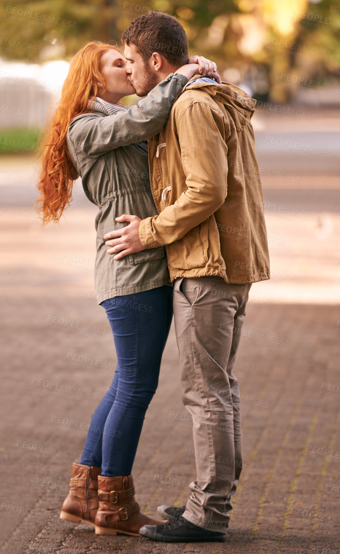 Buy stock photo Couple, love and kiss with affection at park or outdoor in cold weather, together and support in new York. Relationship, date and bonding for romance with desire, care and happiness with commitment