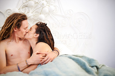 Buy stock photo Love, couple and kiss in bedroom in home for care, connection or embrace together in the morning. Bed, man and woman touch lips for commitment, romantic relationship or relax with dreadlocks in house
