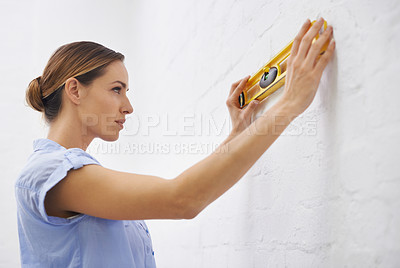 Buy stock photo Level, check and woman by wall in house for interior design or renovation project and tools to align. Female person, remodeling and diy for home improvement or development and repair for upgrade