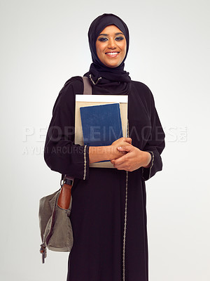 Buy stock photo Portrait, muslim and education with a student woman holding books in studio on a gray background for learning. Islam, university and study with an islamic female at college to study on a scholarship