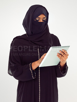 Buy stock photo Woman, tablet and muslim typing with hijab for online islamic research against grey studio background. Female isolated standing holding touchscreen with scarf reading news on islam, arabic or culture