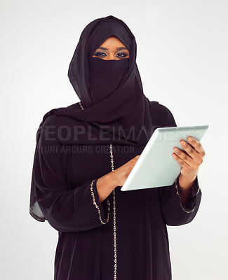 Buy stock photo Portrait, tablet and muslim with a woman in studio on a gray background browsing social media or her news feed. Islam, religion and technology with a female wearing a hijab while surfing the internet