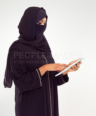 Buy stock photo Woman, tablet and hijab of muslim for online islamic research against a white studio background. Female standing holding touchscreen with scarf reading news on islam, arabic or culture
