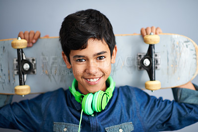 Buy stock photo Portrait, happy and boy with skateboard, headphones and recreation with music and cheerful. Kid, face or childhood with skater or headset with joy or hobby with smile, casual or gen z with confidence