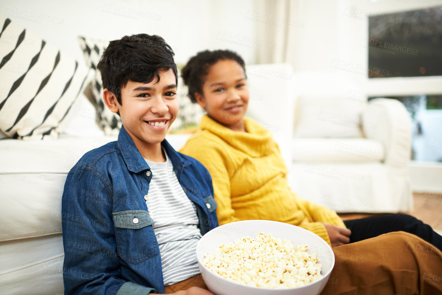 Buy stock photo Happy family, love and popcorn in portrait in home and relax for bonding together on vacation. Brother, sister and positive face of siblings by couch, floor and snack on school holiday in living room