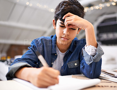 Buy stock photo Image of a young boy doing his homework