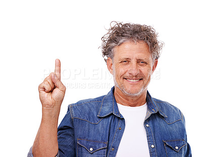 Buy stock photo Studio portrait of a happy mature man pointing upwards isolated on white