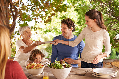 Buy stock photo Food, party and help with family at lunch in nature for health, bonding and celebration. Thanksgiving, social and event with parents and children eating together for dining, generations and wellness