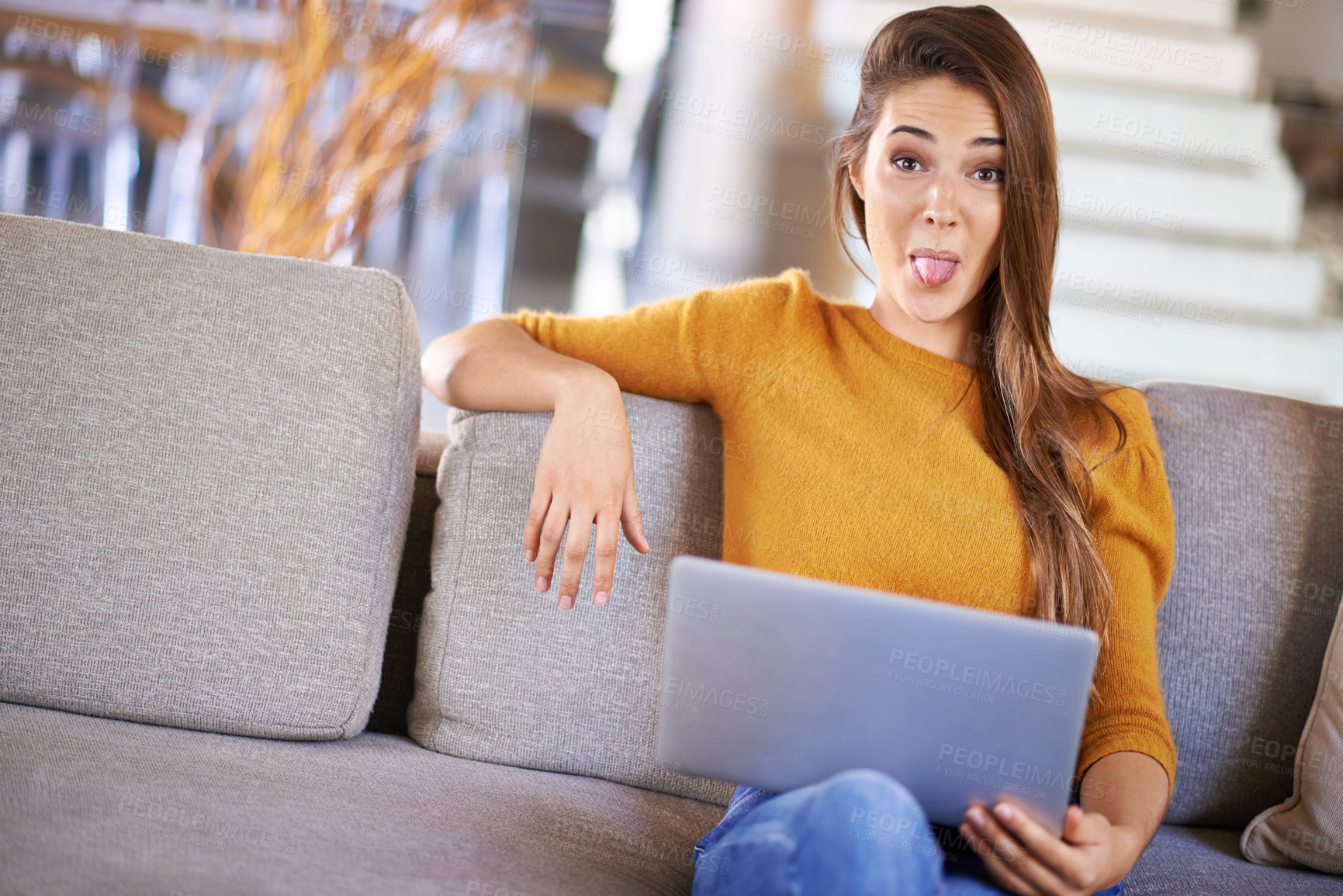 Buy stock photo Tongue out, sofa and portrait of woman with laptop for social media, blog or online research. Female person, technology and playful face with emoji for fun, website or streaming movie on weekend