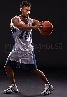 Buy stock photo Man, basketball player and sports game in studio as athlete for workout competition, training or black background. Male person, pass and exercise champion for professional, fitness or mockup space