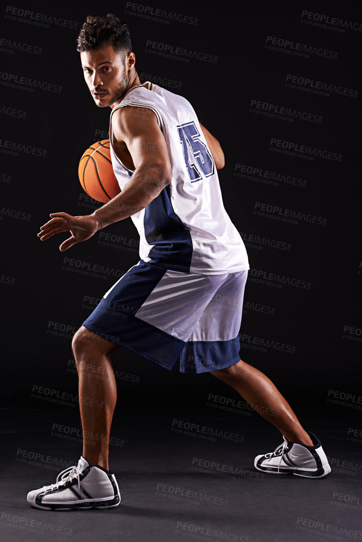 Buy stock photo Studio shot of a basketball player against a black background