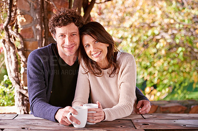 Buy stock photo Portrait, coffee and couple in a backyard, hug and smile with love and nature with sunshine or morning tea. Face, embrace or cappuccino with happiness, woman or man with romance, marriage or vacation