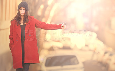 Buy stock photo Portrait of a gorgeous young woman in a red winter coat hailing a cab in the city