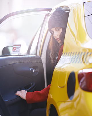 Buy stock photo Portrait of a fashionable young woman getting into a cab in the city