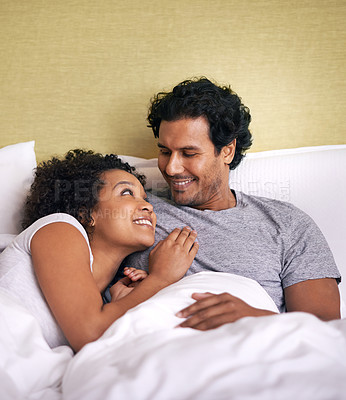 Buy stock photo Bed, woman and man relax with smile, cuddle and rest on soft mattress, love and romance for couple. Partners, male person and girl in bedroom, happy and together in pyjamas, break and weekend