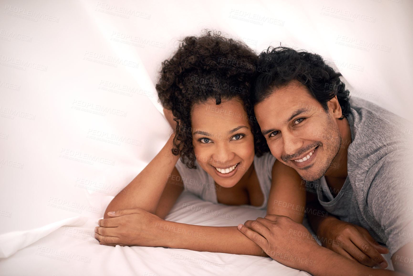 Buy stock photo Couple, portrait and bed with sheet for relax morning or calm for partnership cozy, bonding or apartment. Man, woman and happy under linen or honeymoon love for vacation getaway, carefree or peaceful
