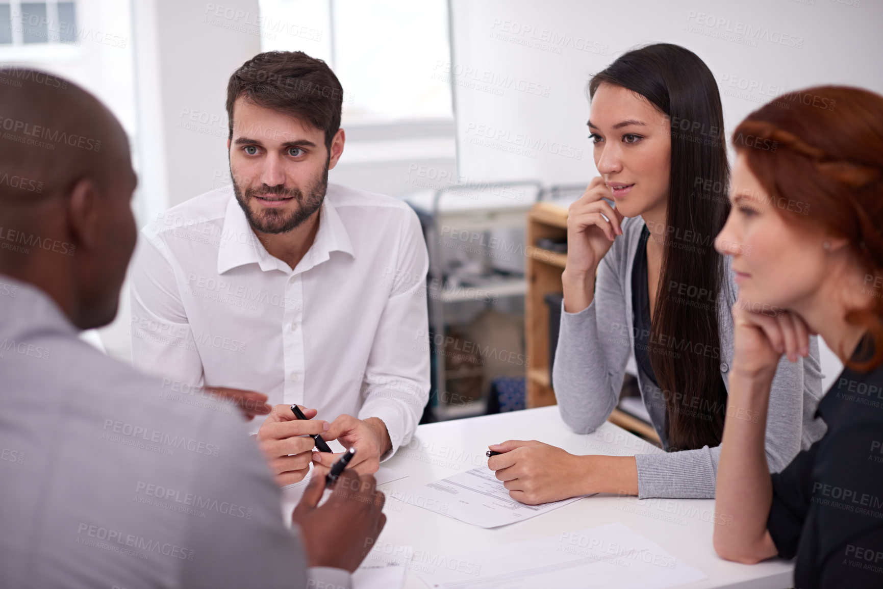 Buy stock photo Shot of a diverse group of young businesspeople having a meeting in an office