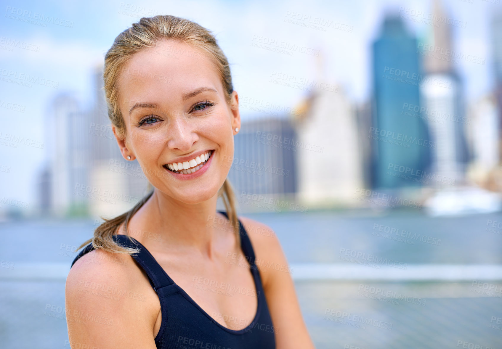 Buy stock photo Portrait, woman and smile at river side with city view on sport clothes to jog, fitness and healthy mindset in New York. Closeup, female person and happiness with self care in summer or hot weather