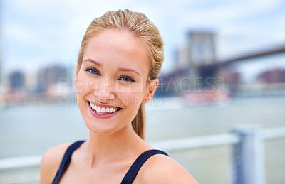 Buy stock photo Woman, happy and smile portrait in city, holiday and tourist with attractive female person in New York. Blue sky, traveling in summer in urban area, relaxing vacation and outdoor wellness by river