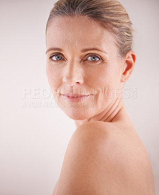 Buy stock photo Cropped studio shot of a beautiful mature woman looking over her shoulder