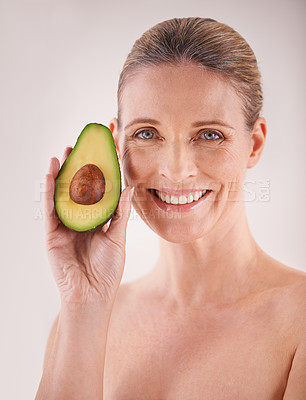 Buy stock photo Beauty, avocado and portrait of woman in studio for health, wellness or natural facial routine. Smile, skincare and mature person with organic fruit for face dermatology treatment by white background