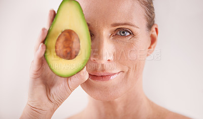 Buy stock photo Cosmetic, avocado and portrait of woman in studio for health, wellness or natural facial routine. Skincare, beauty and mature person with organic fruit for dermatology treatment by white background.