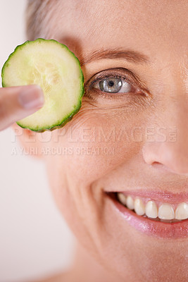 Buy stock photo Skincare, cucumber and portrait of woman in studio for health, wellness or natural facial routine. Smile, beauty and mature person with organic vegetable for dermatology treatment by white background