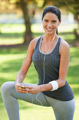 Buy stock photo Woman, portrait and listening to music for stretching in park, fitness and commitment to training for healthy body. Young lady, happy face or runner with streaming radio for morning workout in nature