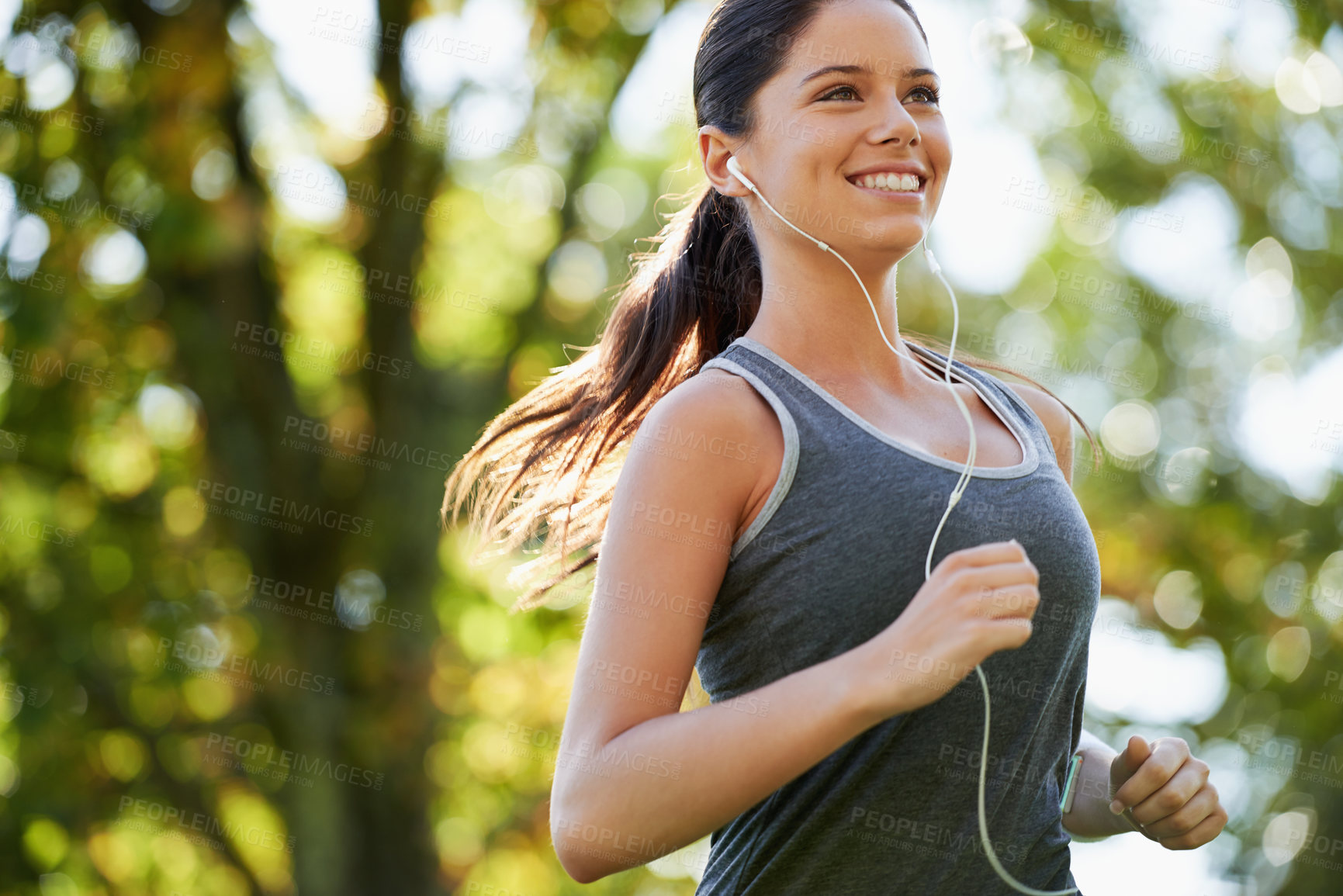 Buy stock photo Fitness, earphones and woman running in a park for health, wellness and outdoor exercise. Nature, sports and female athlete runner doing cardio workout in garden while listening to music and training