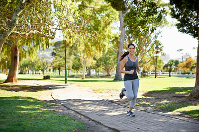 Buy stock photo Full length shot of an attractive young woman running in the park