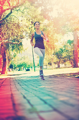 Buy stock photo Shot of a young woman exercising in a park